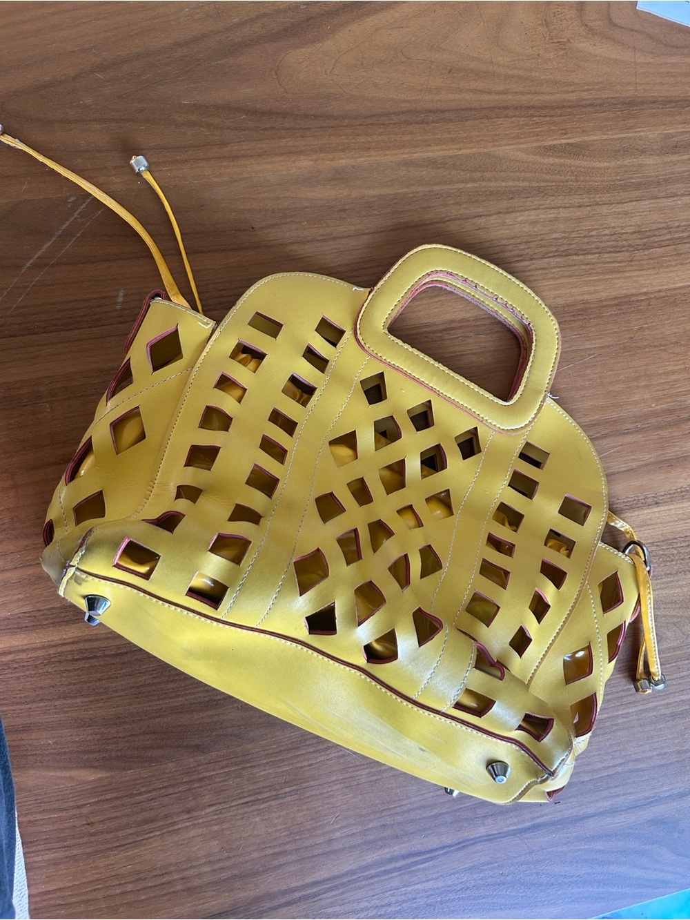 mustard-yellow geometric laser-cut handbag retro inspired